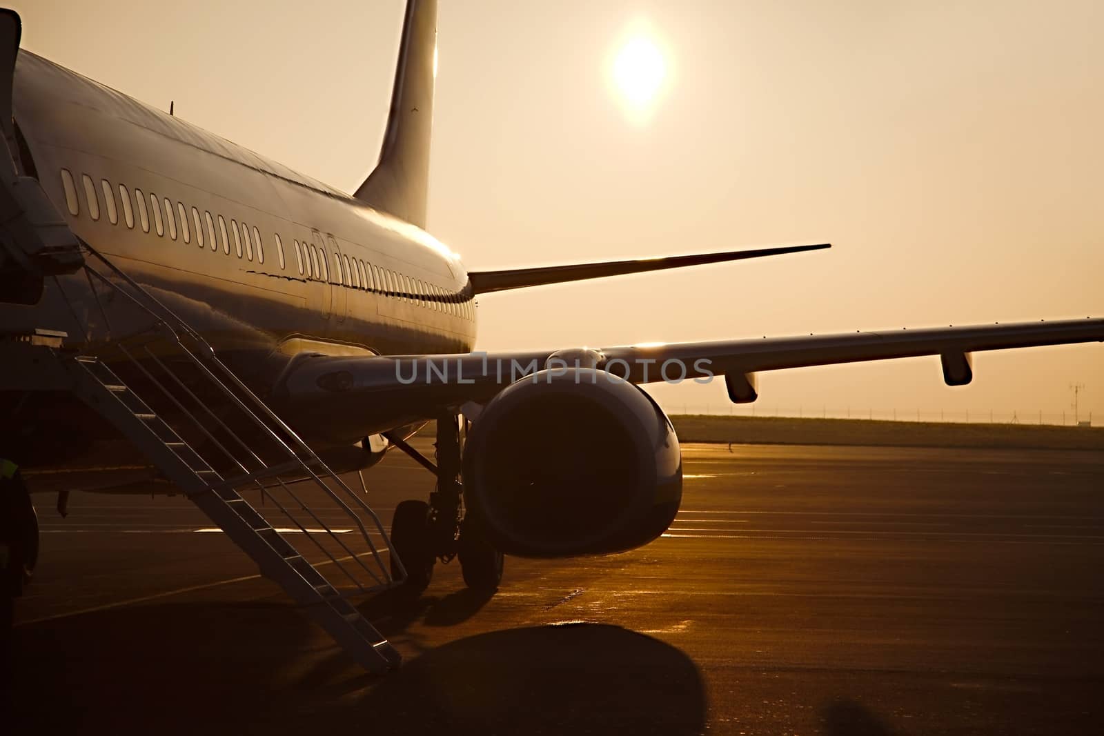 Airplane at an airport at sunrise