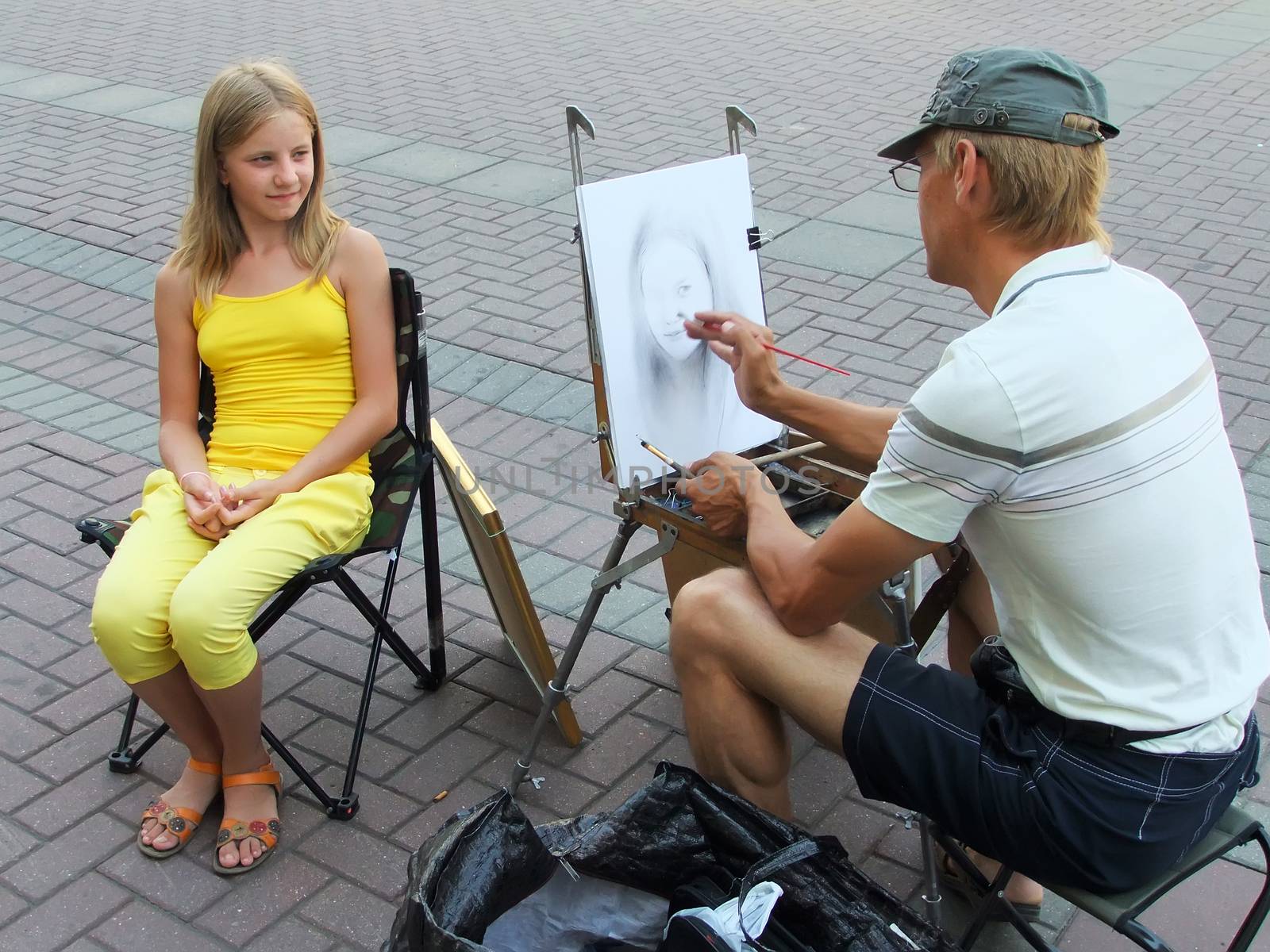 Street artist painting portrait of young girl, Moscow, Russia by donya_nedomam