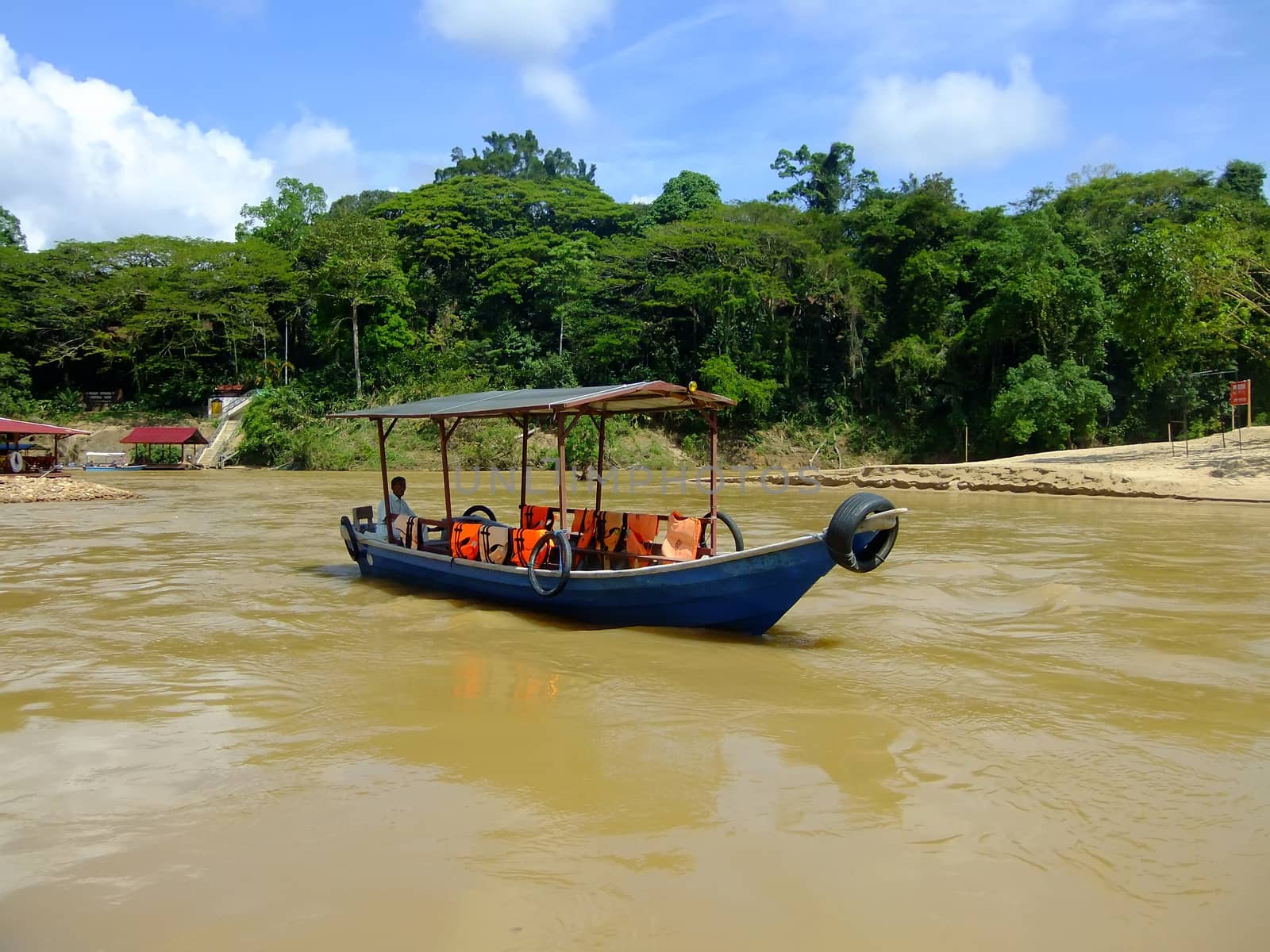 Tourist boat on Tembeling river, Taman Negara National Park, Mal by donya_nedomam