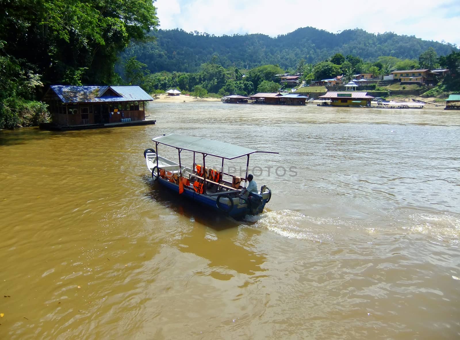 Tourist boat on Tembeling river, Taman Negara National Park, Mal by donya_nedomam