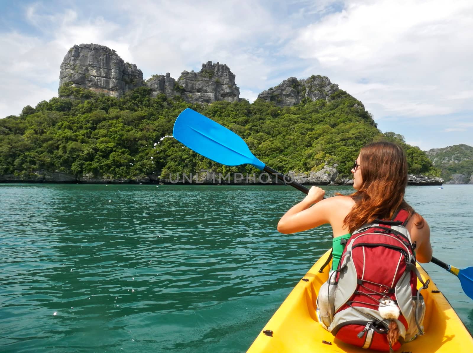 Young woman kayaking in Ang Thong National Marine Park, Thailand by donya_nedomam