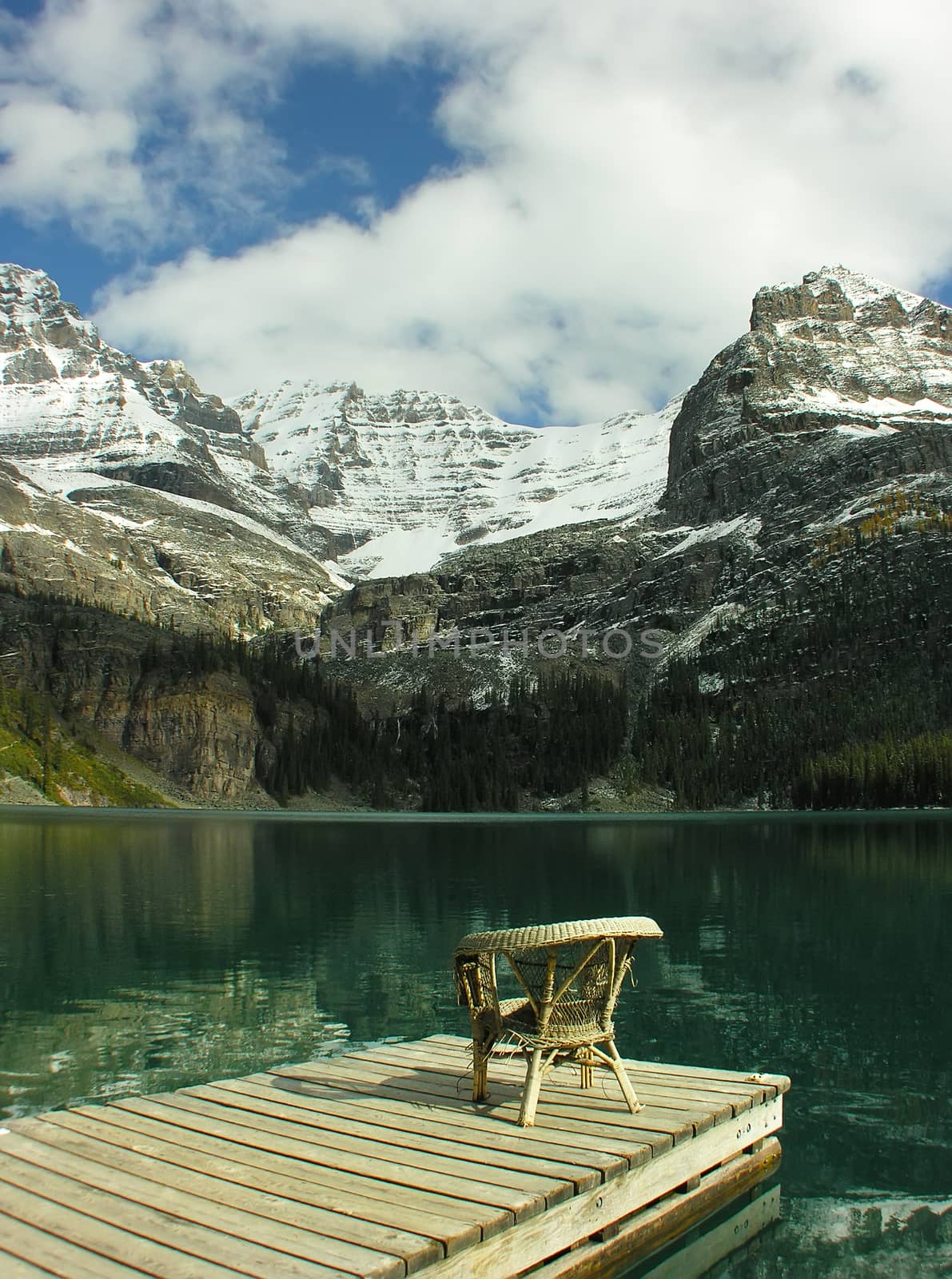 Chair on a wooden pier, Lake O'Hara, Yoho National Park, Canada by donya_nedomam