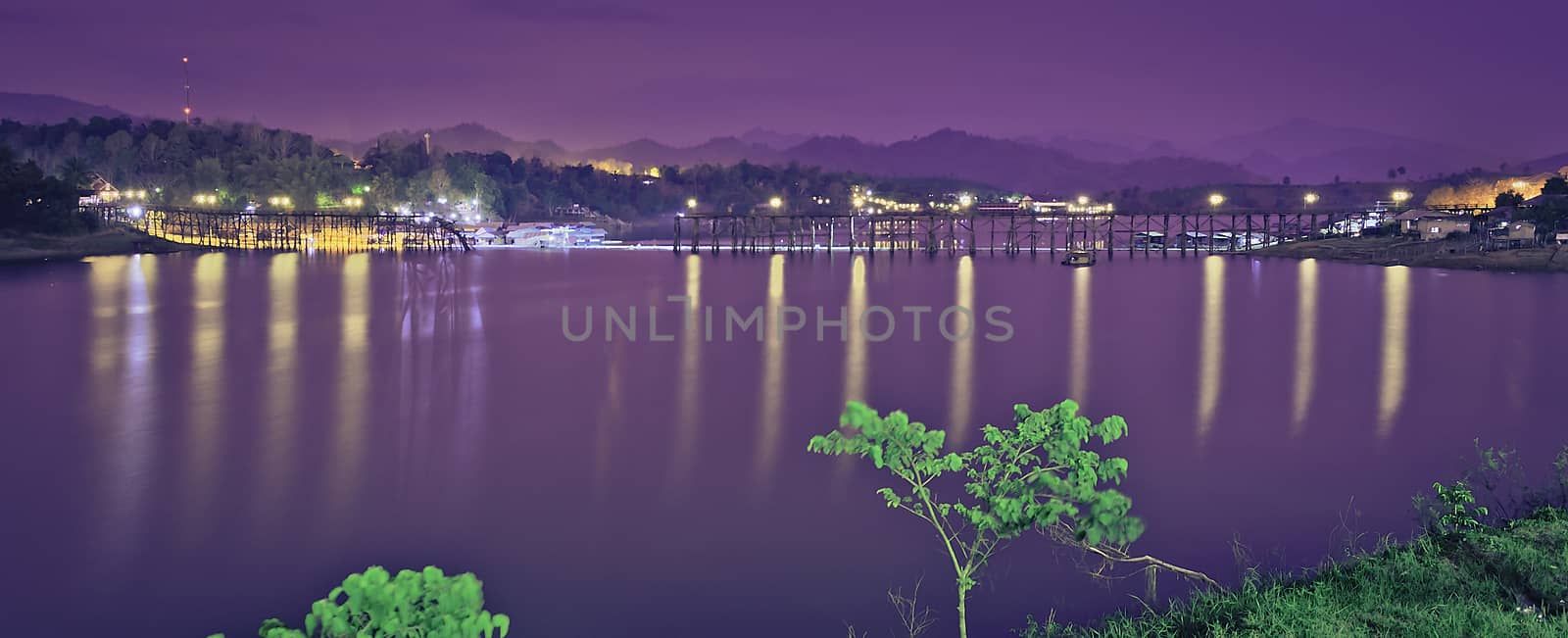 The calm lake on the night with lights.