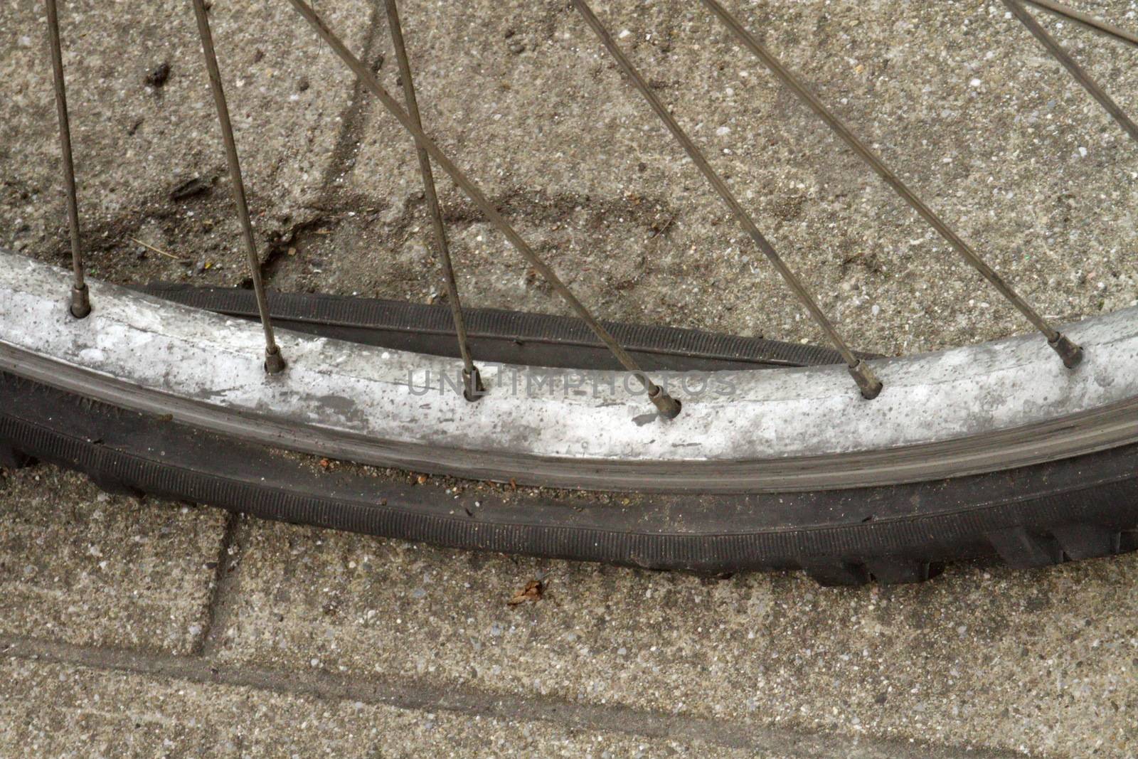 Close up on old flat tire in the street
