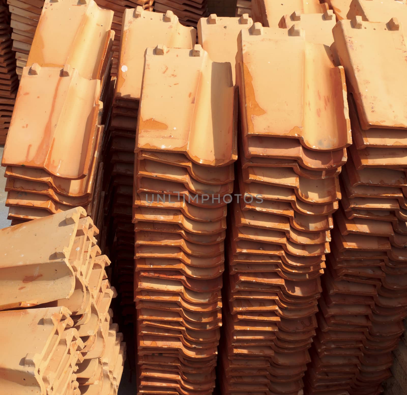 Close up of a stack of ceramic roof tiles.