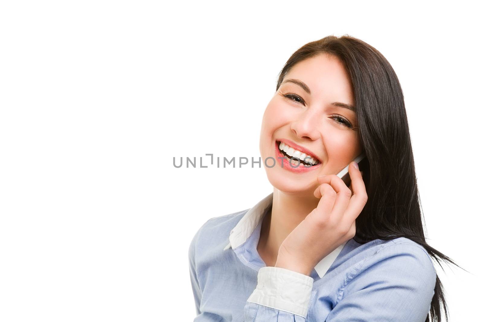 Portrait of smiling young brunette woman talking on the phone