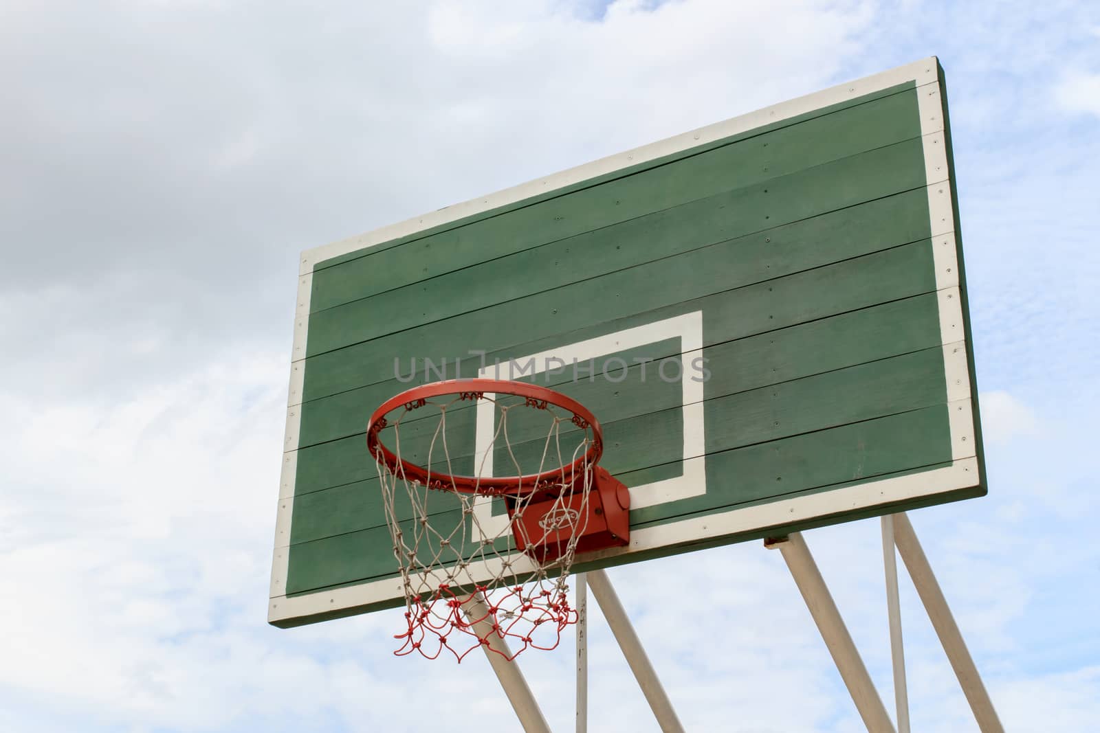 Outdoor Basketball Hoop against a cloudy sky.