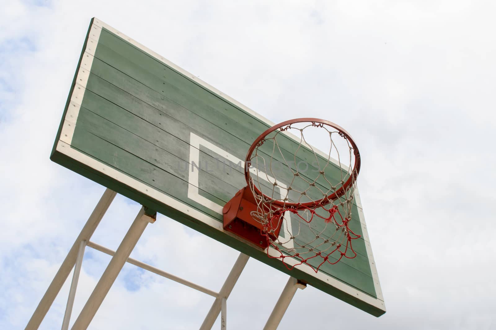 Outdoor Basketball Hoop against a cloudy sky.