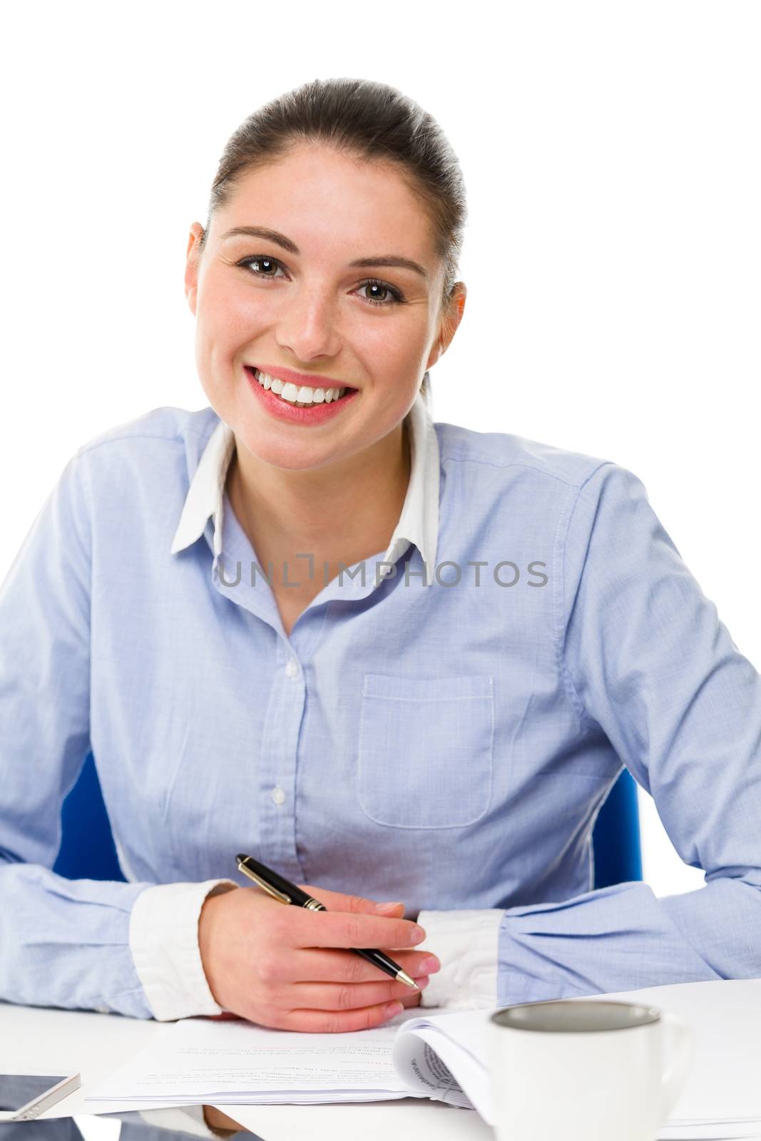 young smiling businesswoman looking at camera on her desk 