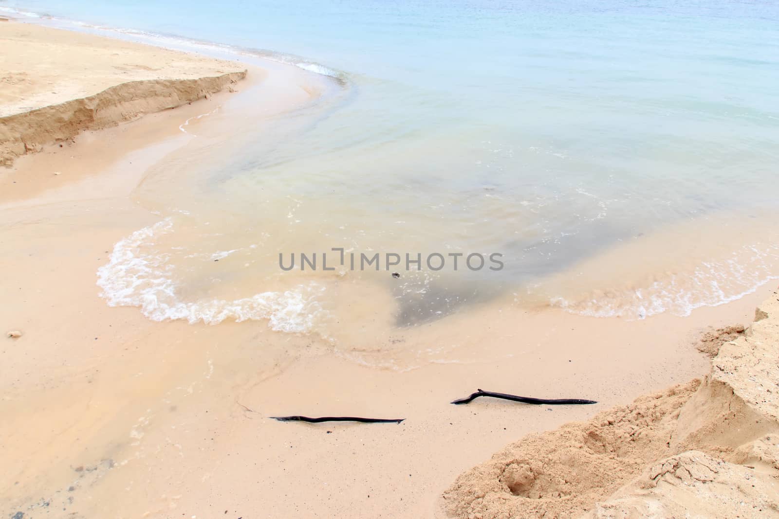 Soft wave of the sea washed the sand away.