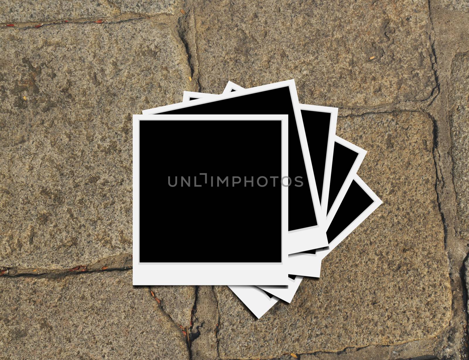 Blank instant photo frames on old brick floor and small cracks. 