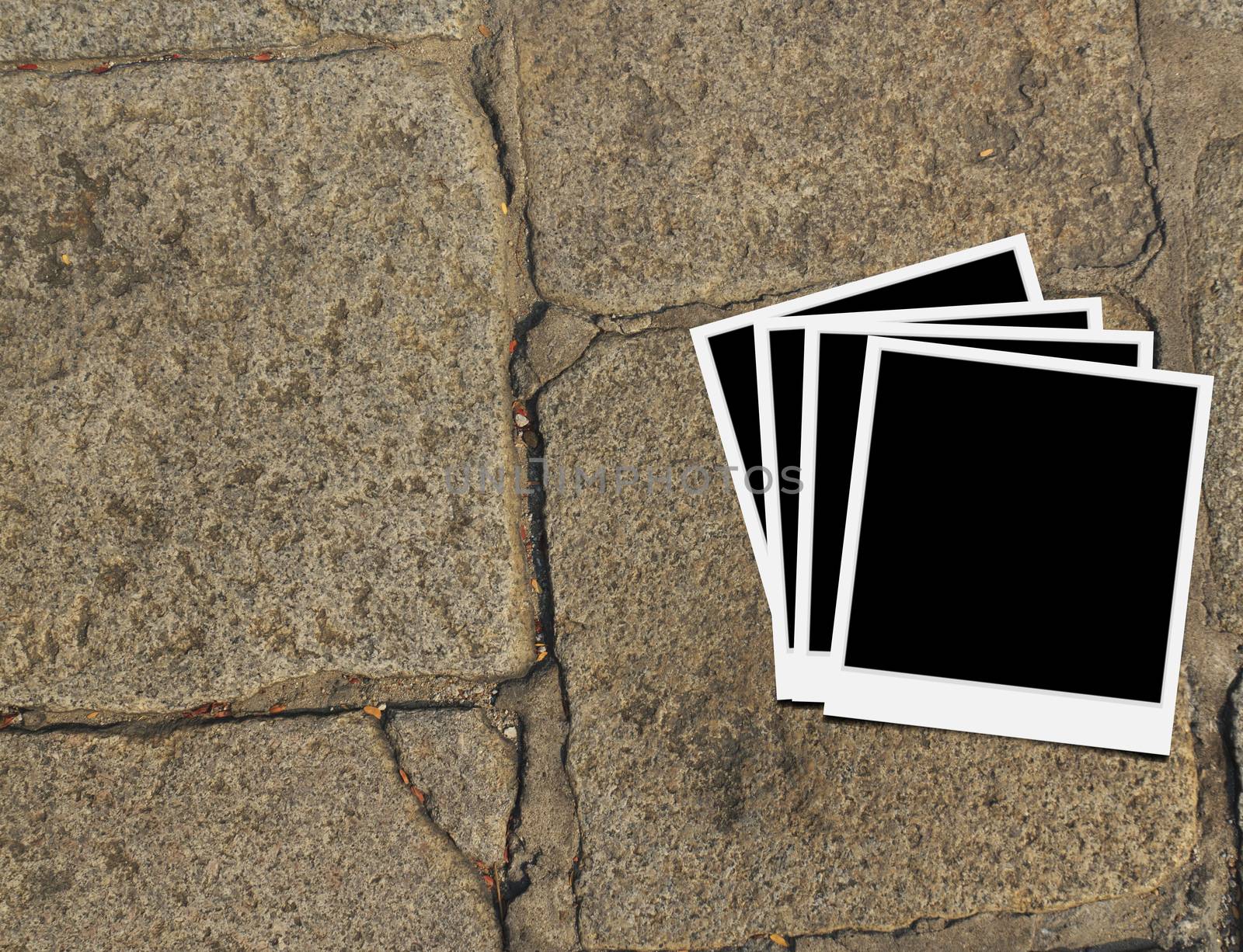 Blank instant photo frames on old brick floor and small cracks. 