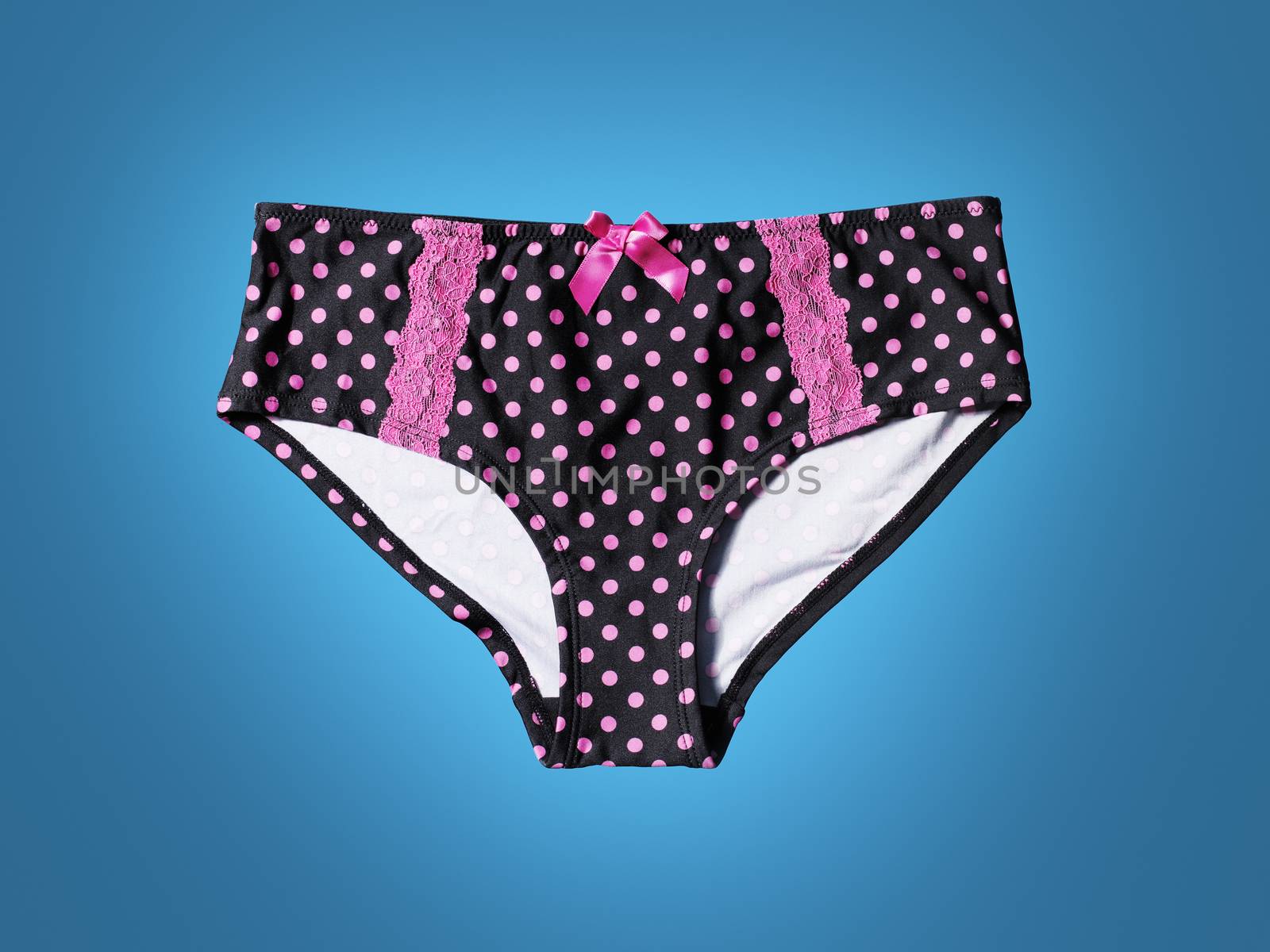 Women's black panties with pink polka dots on blue background.
