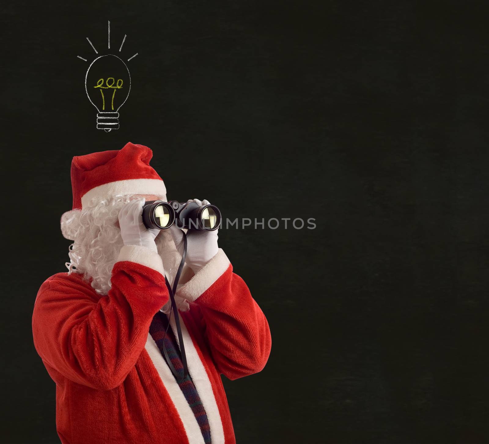 Father Christmas looking at the future business strategy idea with binoculars on backboard background