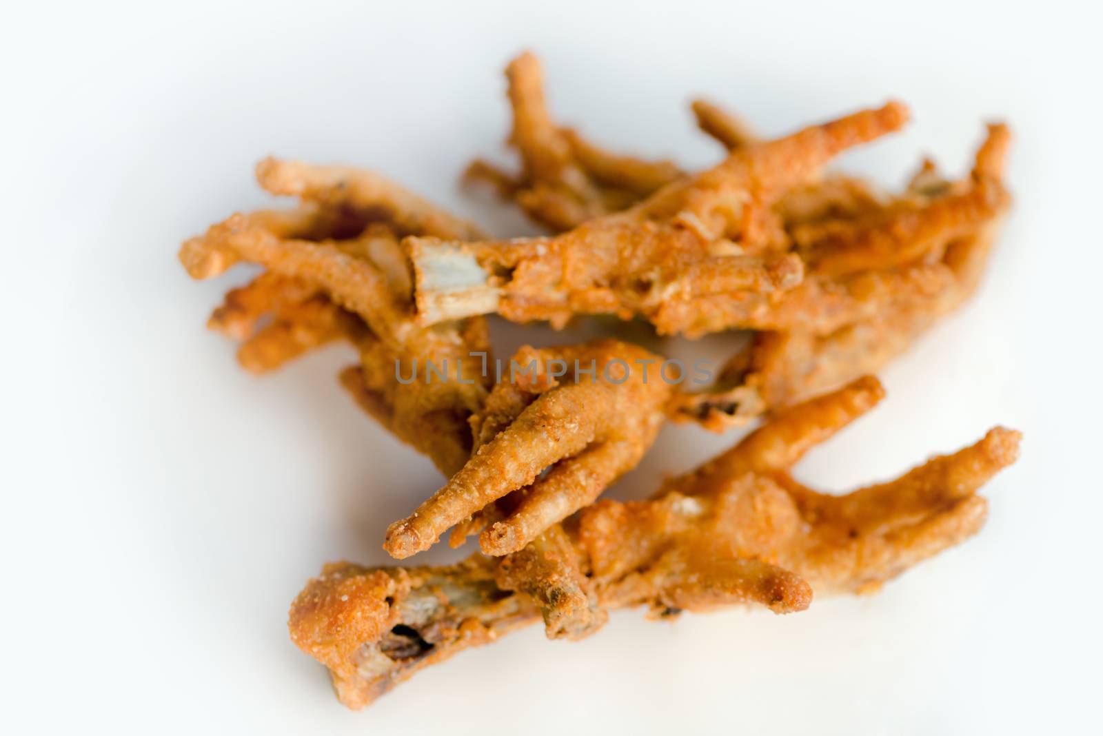 Deep fat fried chicken feet on white plate