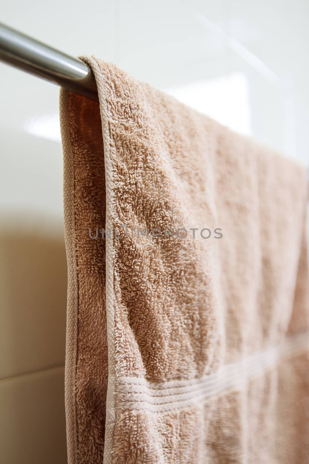 Clean brown towel hangs on a hanger with small depth of field