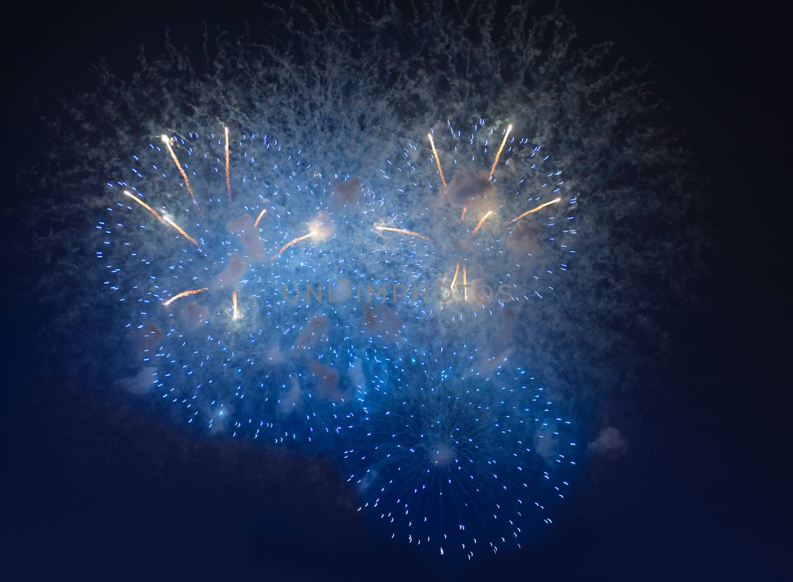 Fireworks in night dark sky with smoke after explosions