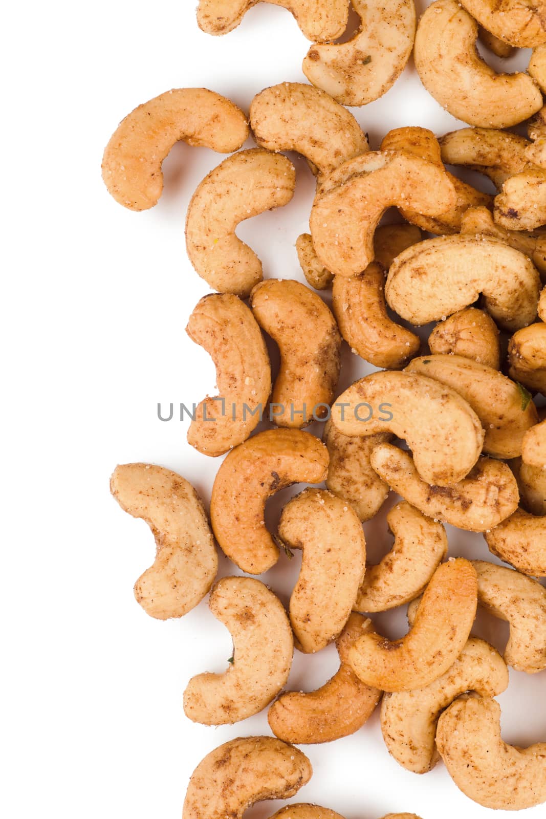 Closeup view of heap of cashew nuts over white background