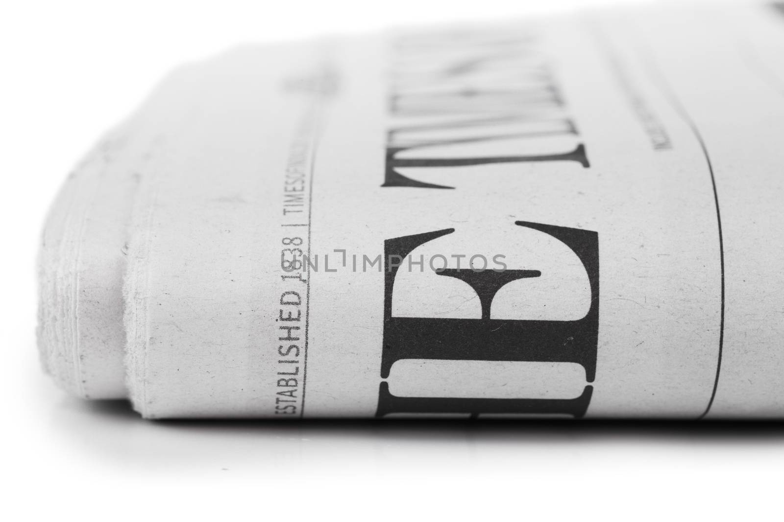 Closeup view of folded newpaper over white background