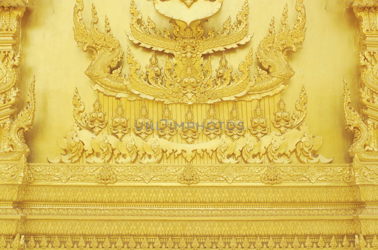 Statue on the walll Thai style art painting on wall of the temple.