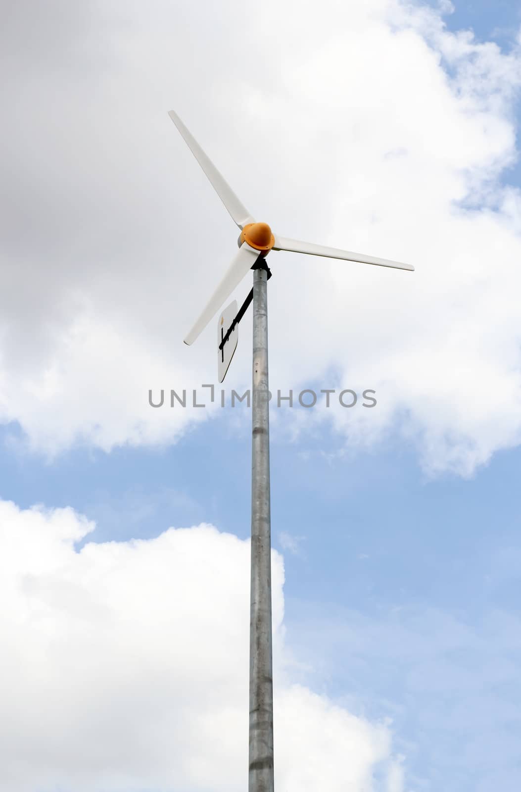 Wind turbine under a blue sky from Lumpini park in bangkok.