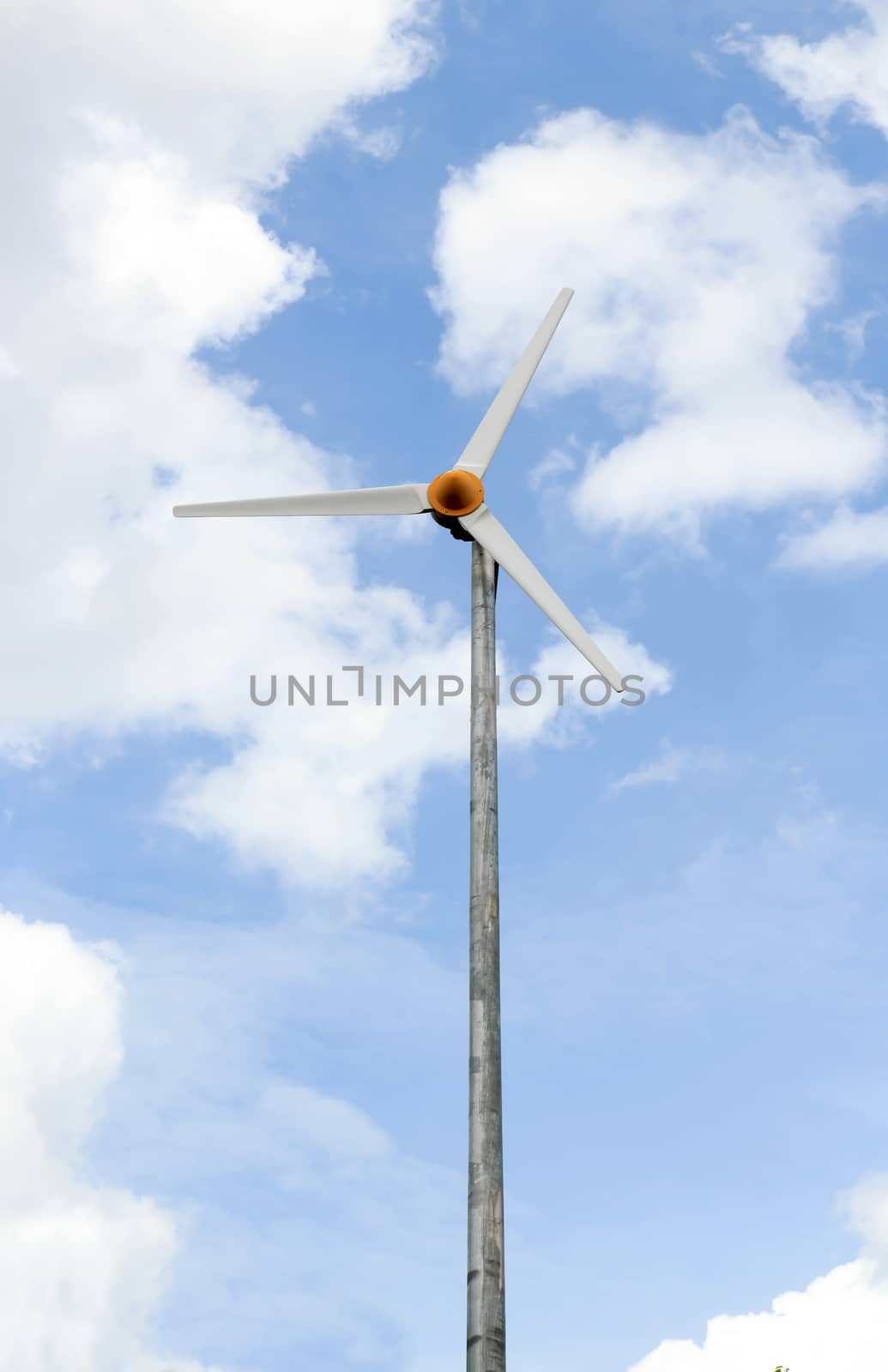 Wind turbine under a blue sky from Lumpini park in bangkok.