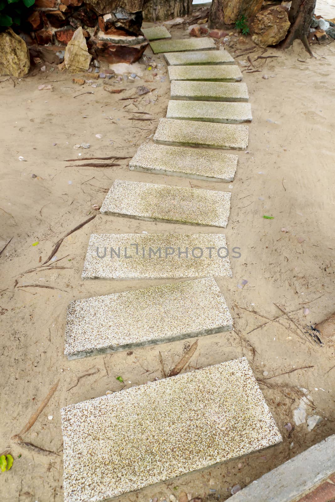 Walkwalk made of bricks in various colors at the beach.