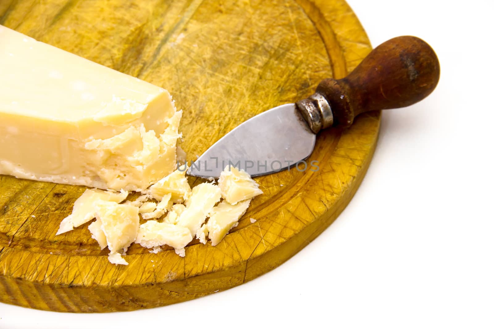 Parmesan cheese on cutting board on white background