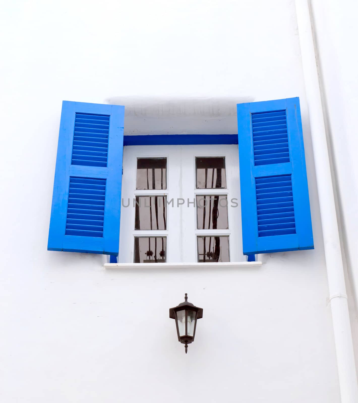 Blue window with white wall of shopping center.