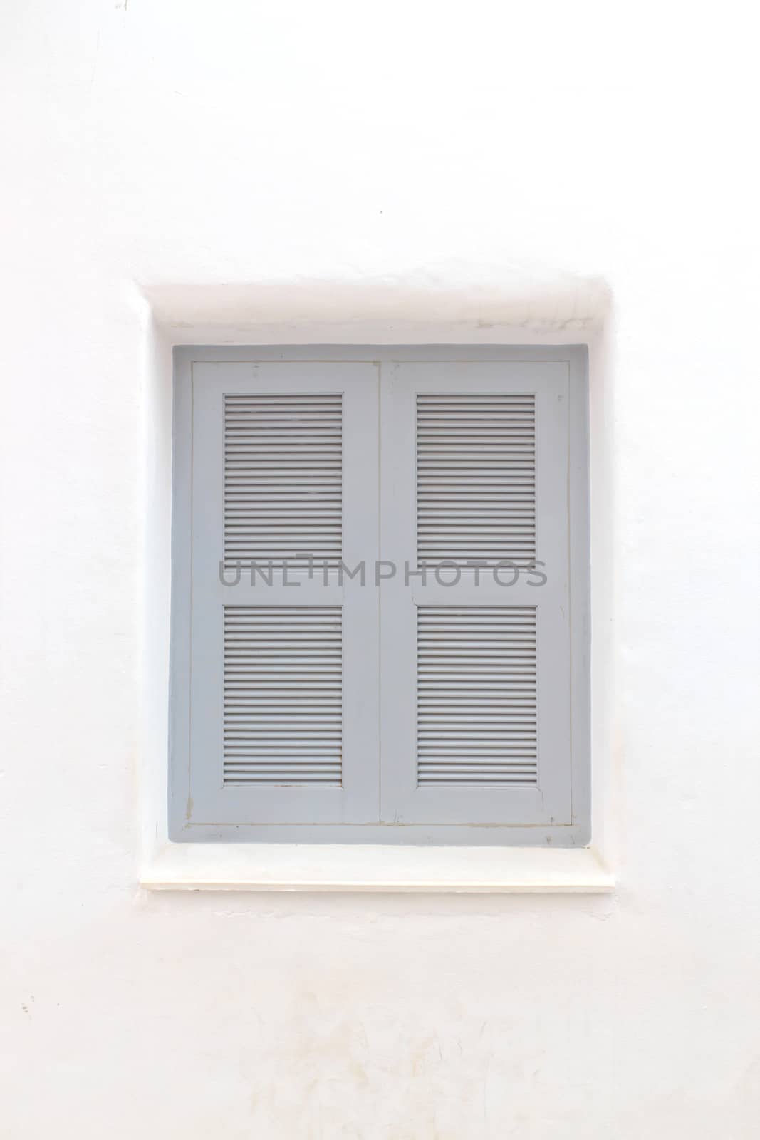 Gray window with white wall of shopping center.