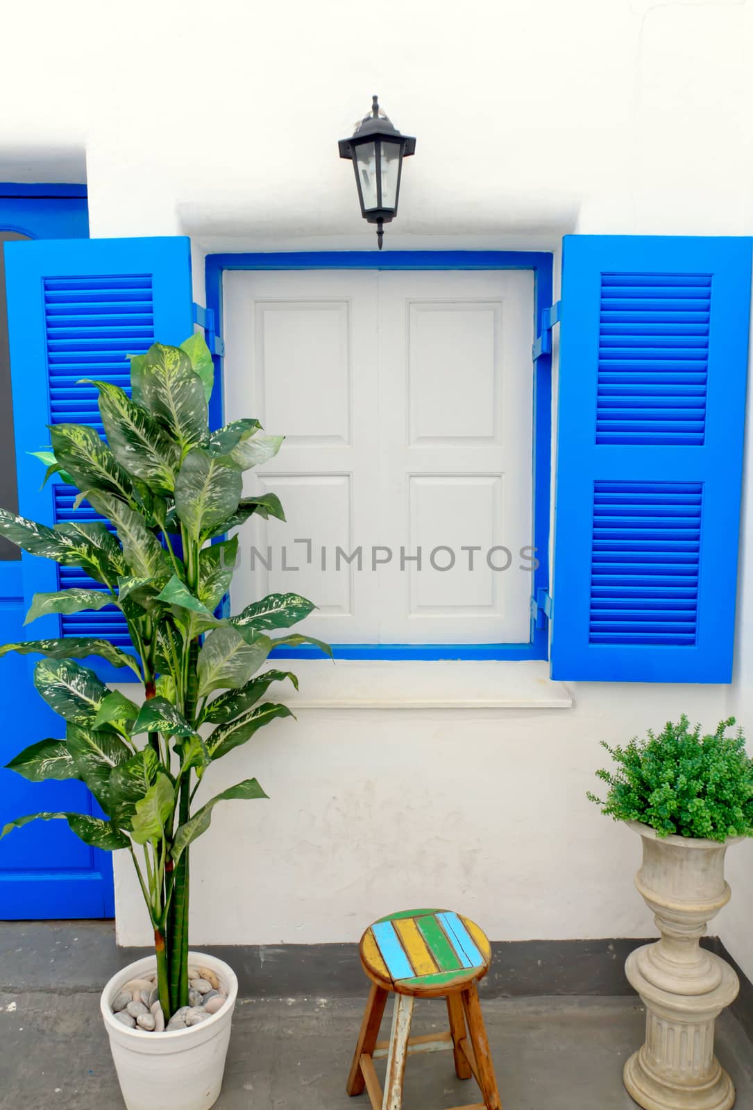 Blue window with white wall of shopping center.