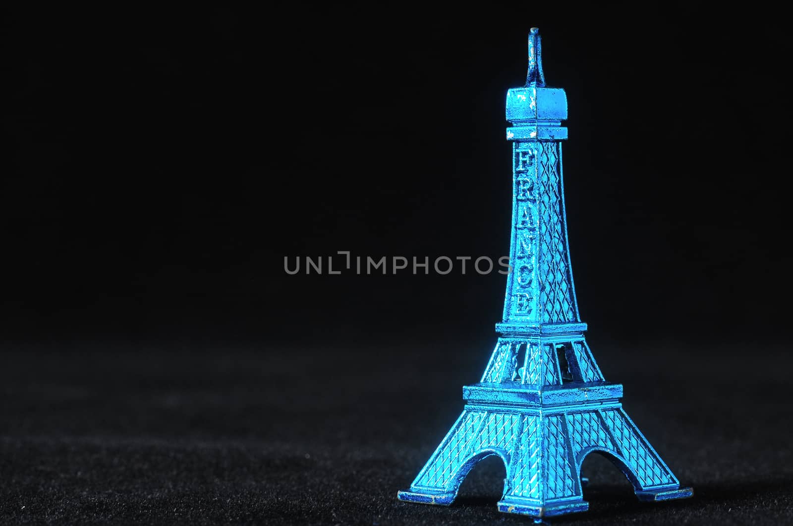 Blue Tour Eiffel Statuette on a Black Background