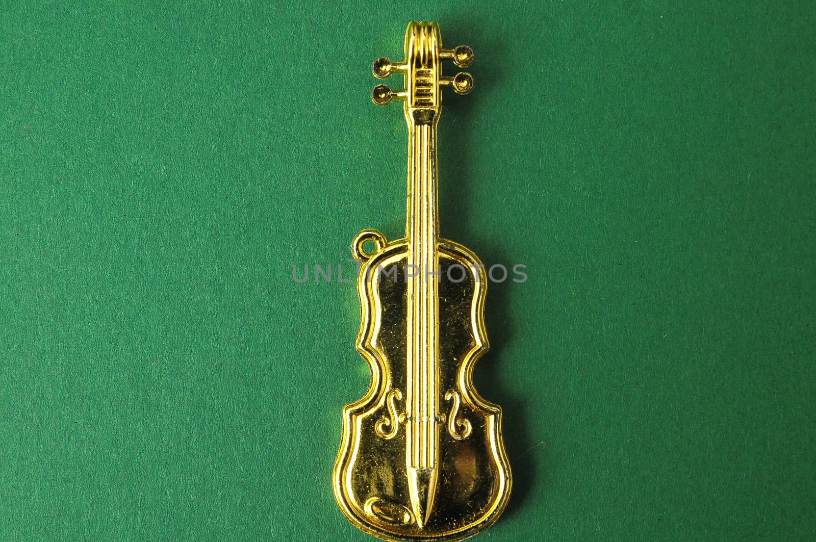 Gold Violin Instrument Figurine on a Colored Background