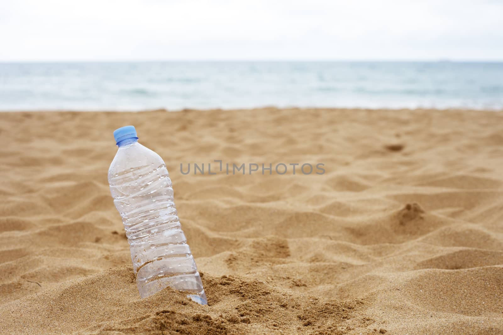 Plastic Bottle Abandoned on the Beach Sand