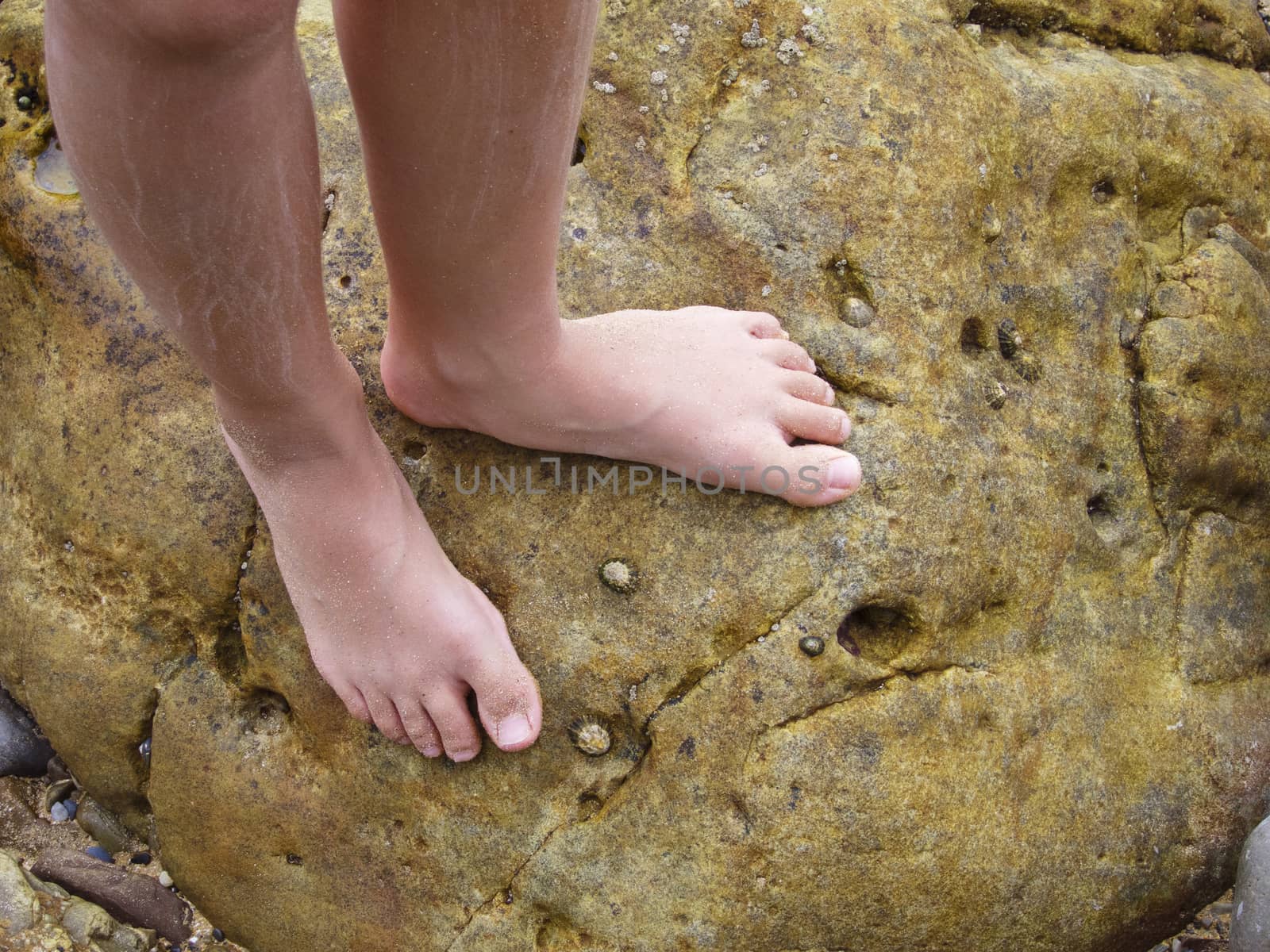 Girl legs walking by the Sea Rocks