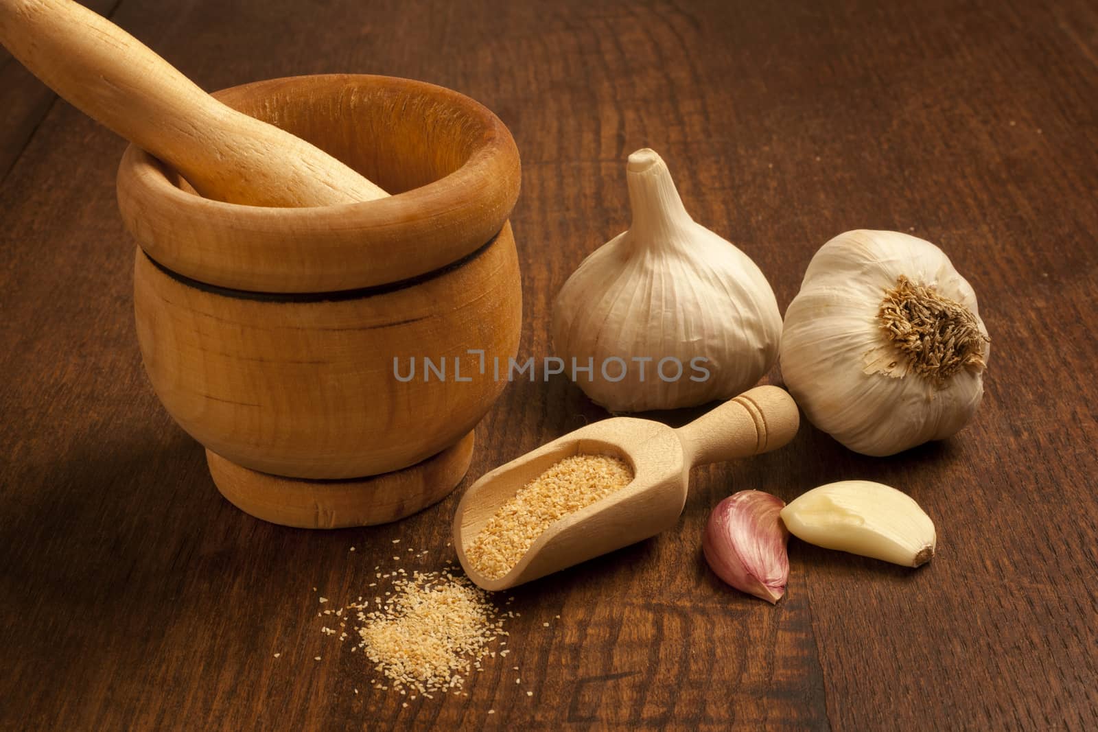 Still life of garlic bulb, mortar and crushed garlic