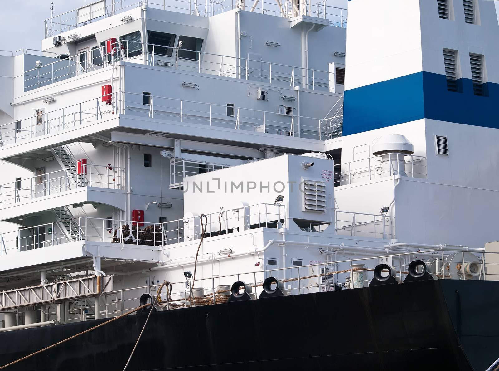 backside view of cargo ship anchored in shipyard