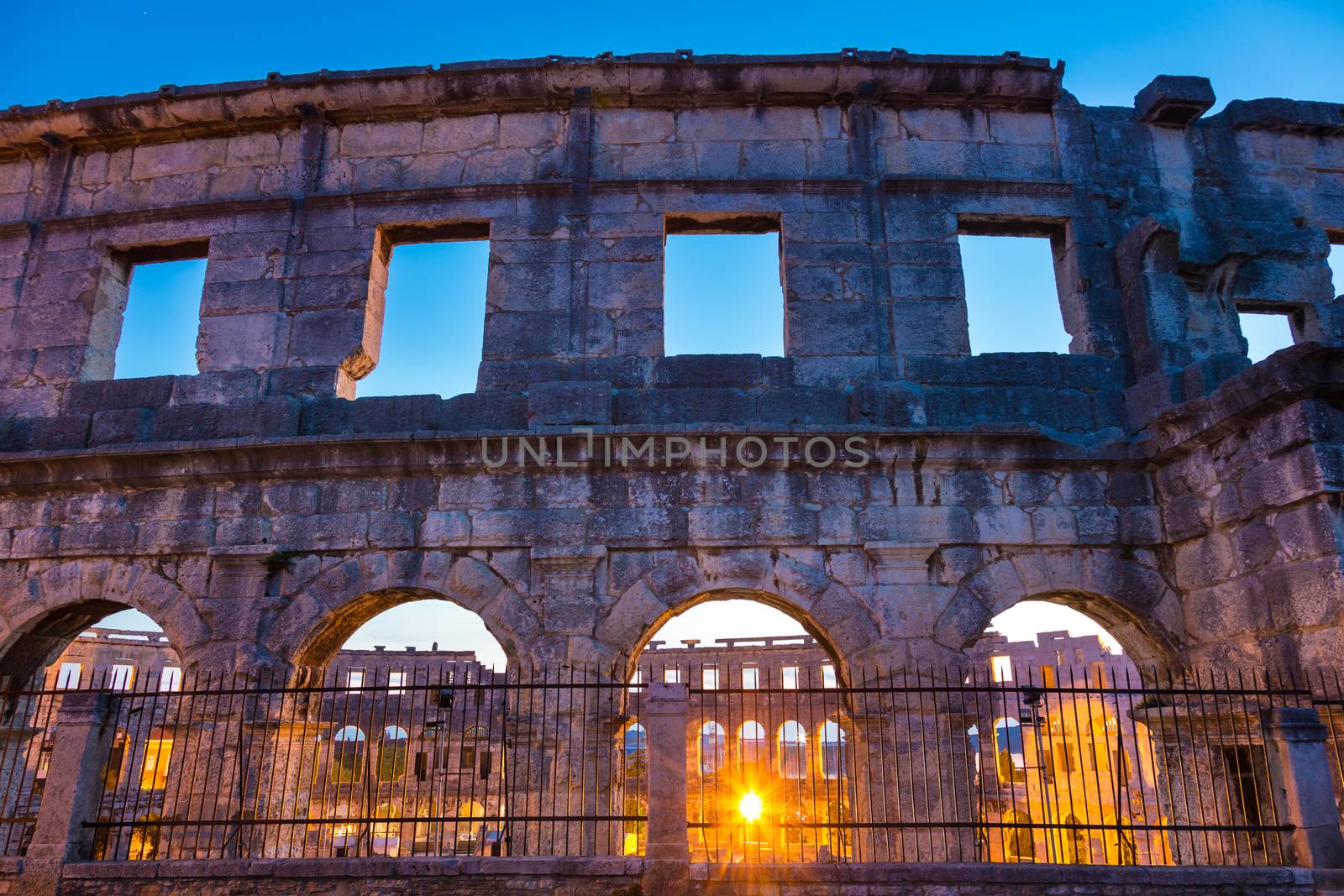 The Roman Amphitheater of Pula, Croatia shot at dusk. It was constructed in 27 - 68 AD and is among the six largest surviving Roman arenas in the World and best preserved ancient monument in Croatia.