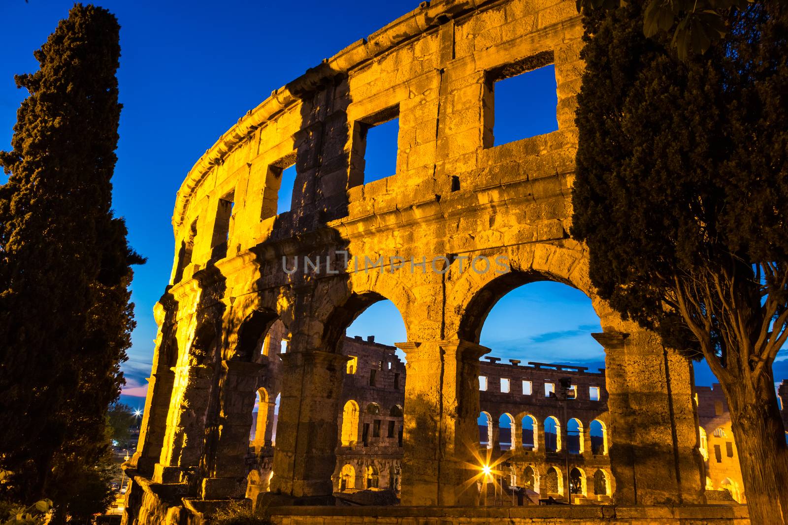 The Roman Amphitheater of Pula, Croatia shot at dusk. It was constructed in 27 - 68 AD and is among the six largest surviving Roman arenas in the World and best preserved ancient monument in Croatia.