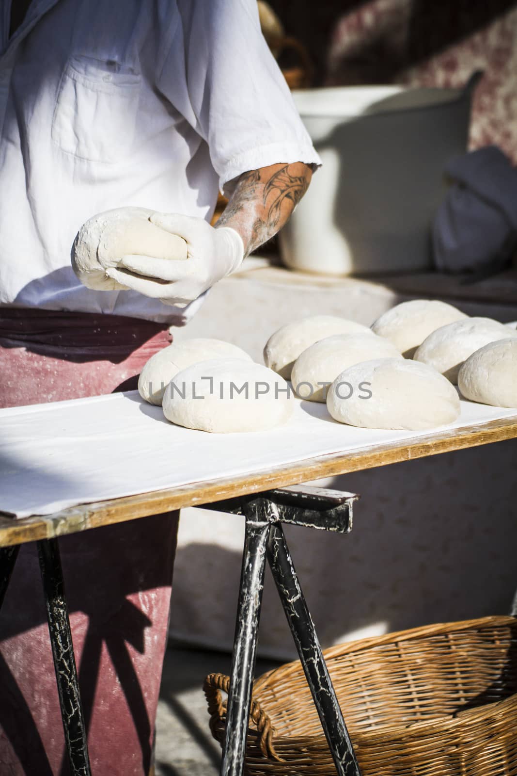 Baker making artisan bread in a medieval fair