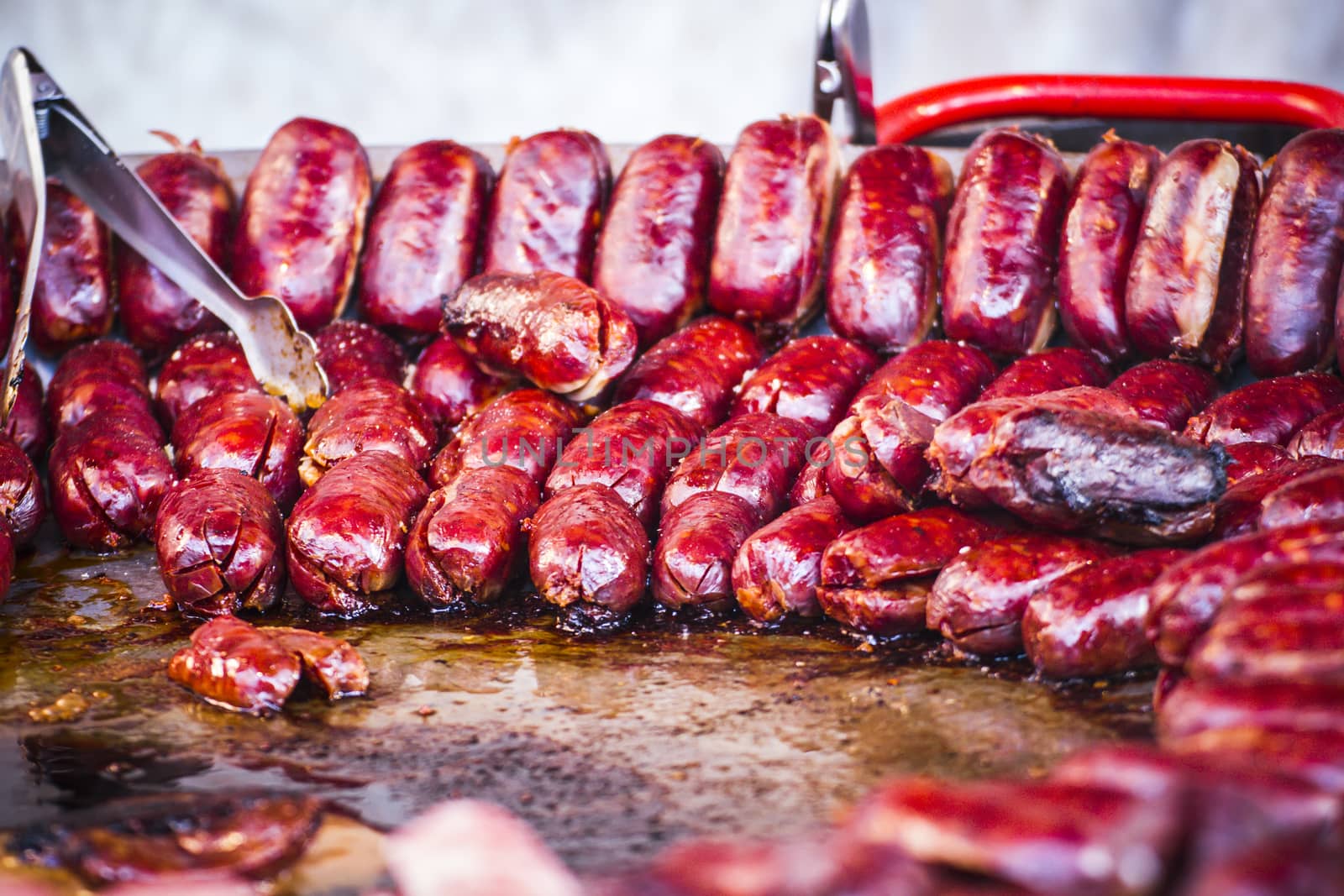 lots of sausages and chorizos in a medieval fair by FernandoCortes