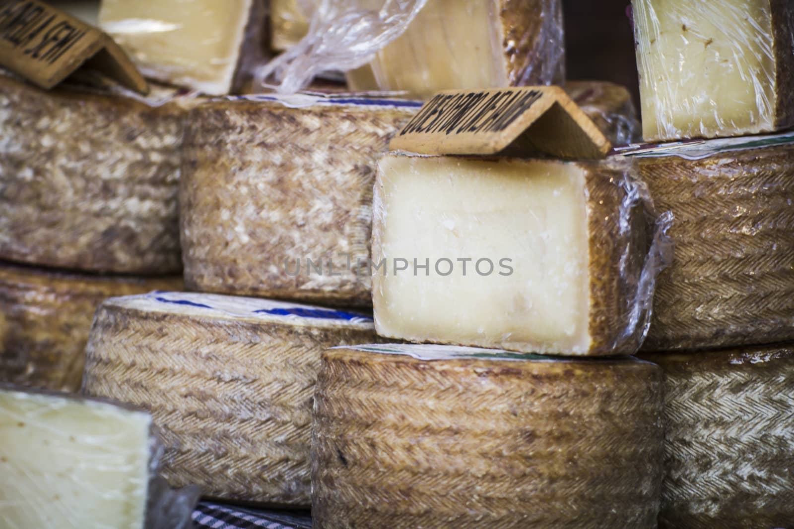 batch of cheese in a medieval fair, artisan cheese by FernandoCortes