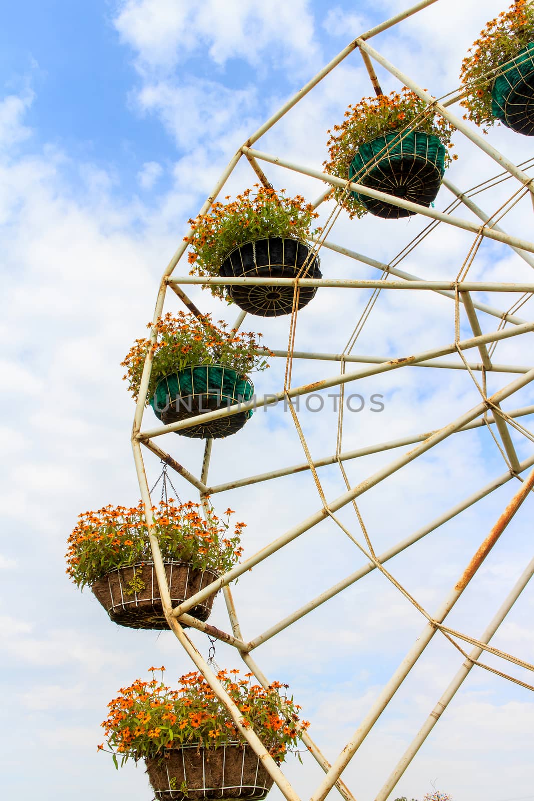 Flower pot is on the ferris wheel.