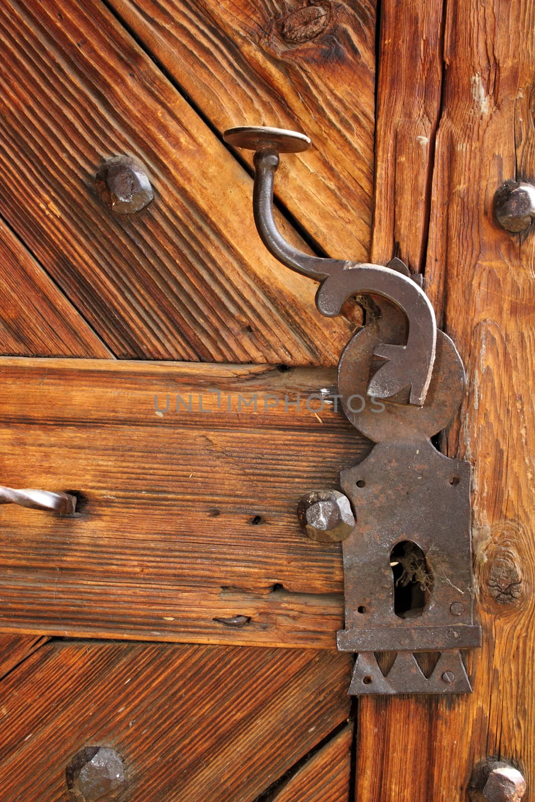 ancient latch on beautiful wooden door, entrance detail of old romanian traditional church