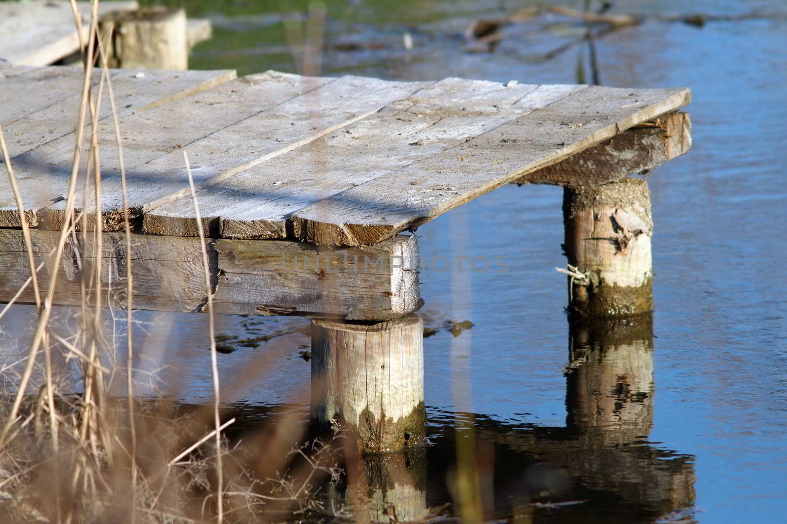 small wooden pontoon for fishing in a pond
