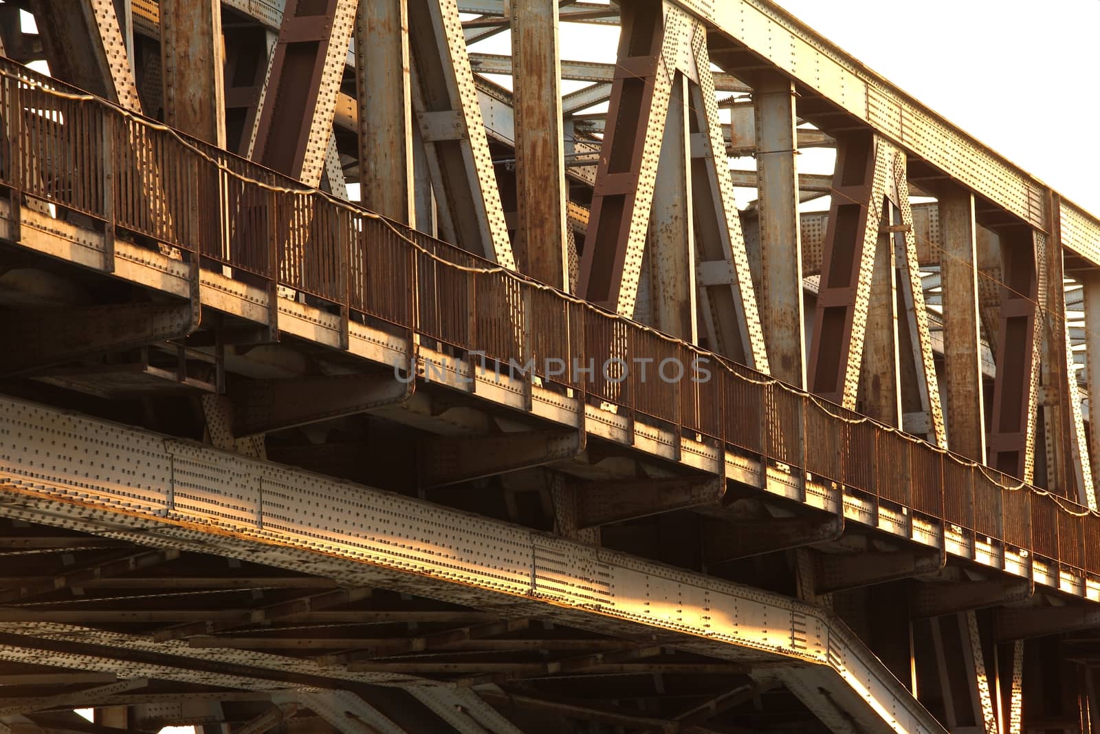 Rusty metal structure of a railway bridge