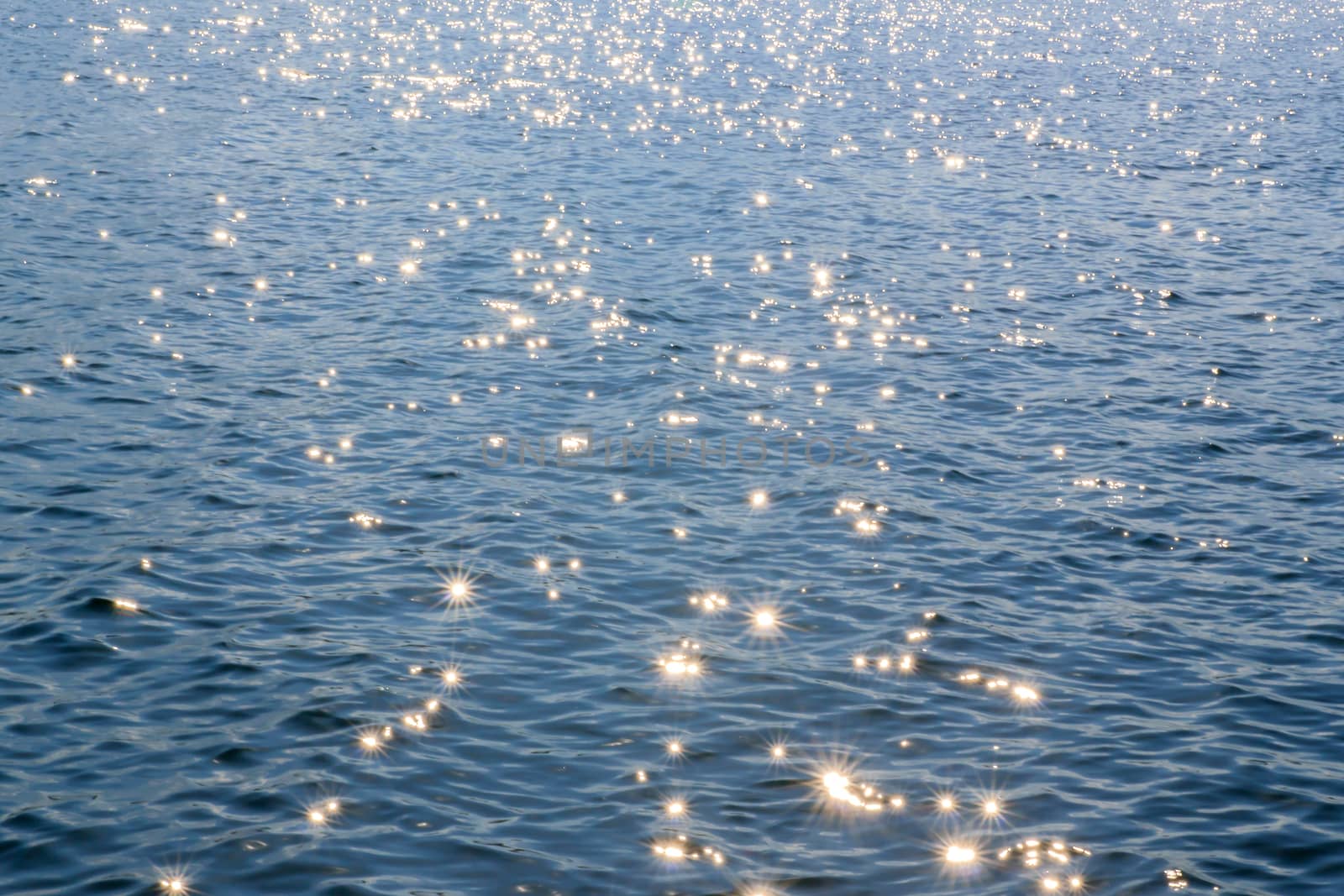 Water with light shining from one lake in the dam.
