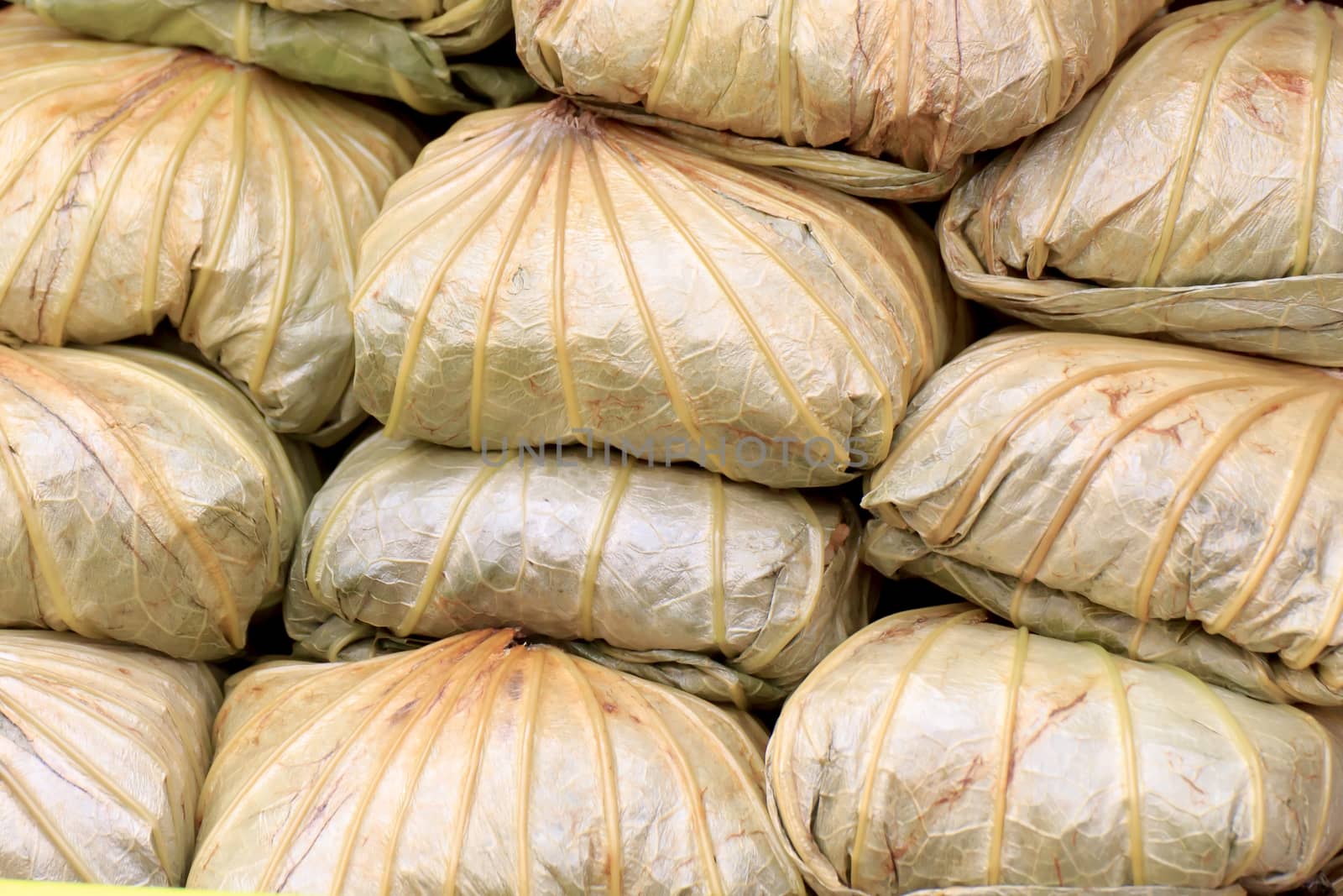 Rice wrapped in lotus leaves, large and overlapping.