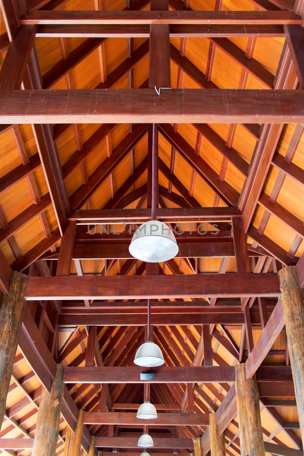 The inside of wooden Thai roof with lanterns.