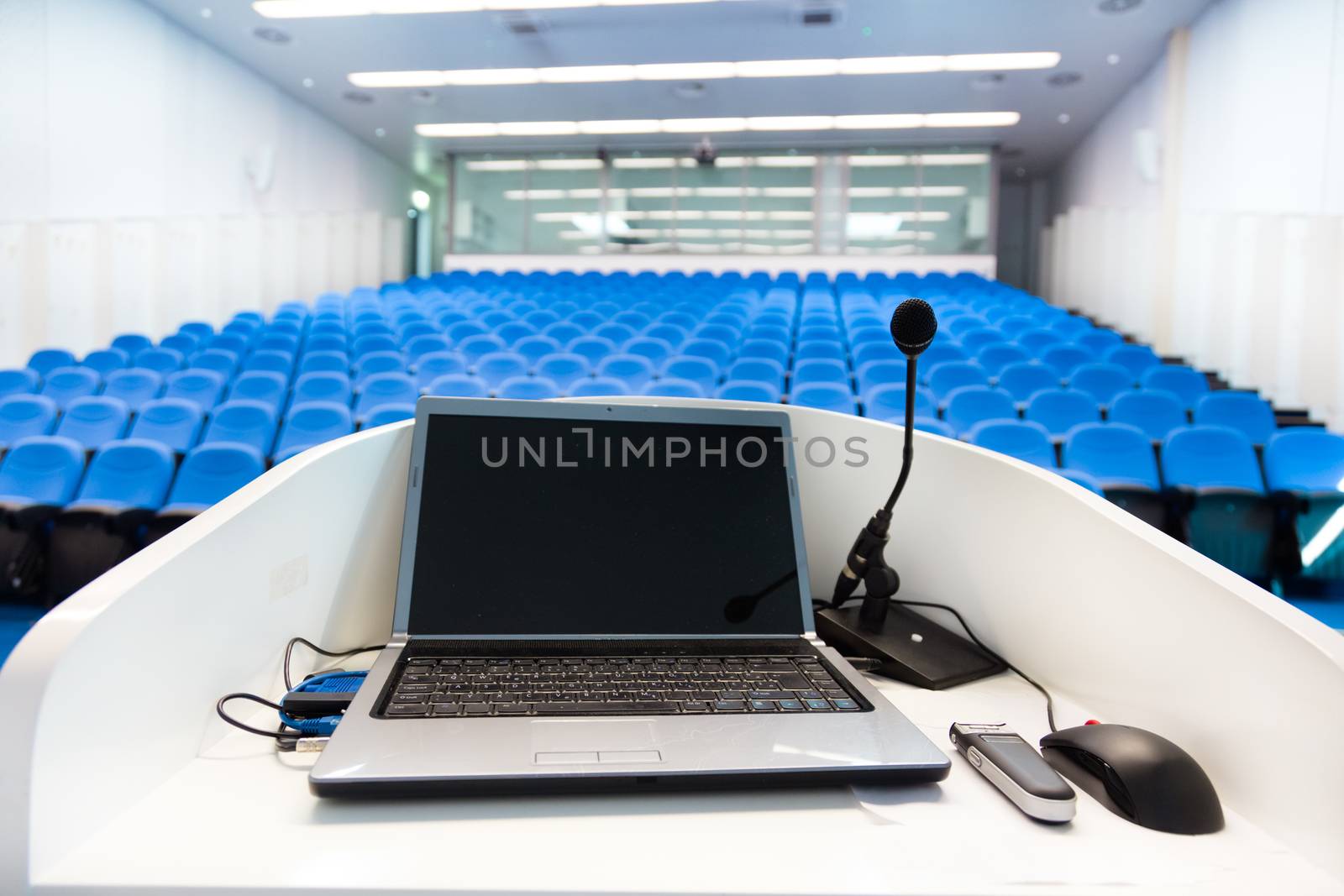 Laptop on the rostrum in conference hall. by kasto